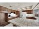 A spacious kitchen with custom wood cabinets, white countertops, and modern appliances at 5890 W Patrick Ln, Las Vegas, NV 89118