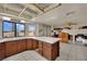 Open concept kitchen with tile countertops and views of the backyard at 5890 W Patrick Ln, Las Vegas, NV 89118