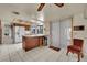 Kitchen features an island with seating, white appliances, and tile flooring at 5890 W Patrick Ln, Las Vegas, NV 89118