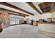 Spacious living room with a stone fireplace, bar area, and sliding glass doors to the pool at 5890 W Patrick Ln, Las Vegas, NV 89118