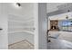 View of an open-concept living room adjacent to a room with open shelving at 5890 W Patrick Ln, Las Vegas, NV 89118