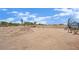 An empty yard with a mound of dirt, a metal fence, and a shed, ideal for customization at 5890 W Patrick Ln, Las Vegas, NV 89118