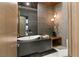 Modern powder room with vessel sink, accent lighting, and unique stone flooring at 6 Vista Crescent Ct, Henderson, NV 89012
