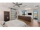 Stylish bedroom featuring a barn door to the en-suite bathroom, ample natural light, and sleek furnishings at 6 Vista Crescent Ct, Henderson, NV 89012