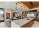 Bright kitchen with stainless steel appliances, marble countertops, and an open layout to the living area at 6 Vista Crescent Ct, Henderson, NV 89012