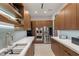 Sleek kitchen featuring modern appliances, wooden cabinetry, and white countertops at 6 Vista Crescent Ct, Henderson, NV 89012