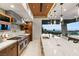 Gourmet kitchen with stainless steel appliances and marble countertops overlooking a city view at 6 Vista Crescent Ct, Henderson, NV 89012