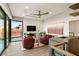 Cozy living room with a fireplace, comfortable seating, and sliding glass doors to a balcony with a view at 6 Vista Crescent Ct, Henderson, NV 89012