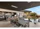 Beautiful outdoor kitchen with grill, bar seating, dining table and reflecting pool for elegant outdoor living and entertaining at 6 Vista Crescent Ct, Henderson, NV 89012