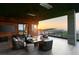Comfortable outdoor lounge featuring modern seating, a fireplace and panoramic sunset views for elegant outdoor relaxation at 6 Vista Crescent Ct, Henderson, NV 89012
