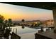 Inviting infinity pool and seating area with stunning sunset views, ideal for relaxing and enjoying the desert landscape at 6 Vista Crescent Ct, Henderson, NV 89012