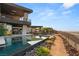 Beautiful backyard featuring a large pool, desert landscaping and an amazing modern architectural design with black accents at 6 Vista Crescent Ct, Henderson, NV 89012