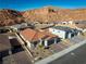 Aerial view of a home in a desert neighborhood with scenic mountain views at 647 Quarry Pass, Mesquite, NV 89034