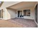 Covered patio with brick pavers, seating, and grill for outdoor living and entertainment at 647 Quarry Pass, Mesquite, NV 89034