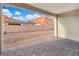 Gravel backyard featuring a covered patio with brick pavers and a view of the surrounding mountains at 647 Quarry Pass, Mesquite, NV 89034