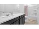 Well-lit bathroom with quartz countertops, dark wood cabinets, and a shower-tub combo at 647 Quarry Pass, Mesquite, NV 89034