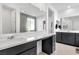 Spa-like bathroom featuring stone accents, a large mirror, and sleek vanity at 647 Quarry Pass, Mesquite, NV 89034