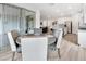 Open-concept view of a dining area and living area, filled with natural light and stylish furniture at 647 Quarry Pass, Mesquite, NV 89034