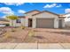 Charming single-story home featuring a brick driveway, two-car garage, desert landscaping, and a tile roof at 647 Quarry Pass, Mesquite, NV 89034