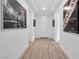 Entryway featuring wood floors, modern art, tray ceiling, and a white front door at 647 Quarry Pass, Mesquite, NV 89034