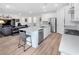 Open kitchen with stainless steel appliances and island, seamlessly connected to a cozy living area at 647 Quarry Pass, Mesquite, NV 89034