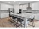 Stylish kitchen featuring a large island with seating, stainless steel appliances, and white cabinets at 647 Quarry Pass, Mesquite, NV 89034
