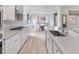 Modern kitchen with white cabinetry and long island, adjacent to a bright dining area and backyard view at 647 Quarry Pass, Mesquite, NV 89034