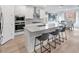 Bright kitchen with quartz counters, island seating, stainless appliances, and an adjacent dining area at 647 Quarry Pass, Mesquite, NV 89034
