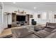 Cozy living area with a wooden entertainment center, leather sofa, and stylish decor at 647 Quarry Pass, Mesquite, NV 89034