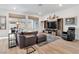 Bright living room with wood floors, a large TV, cozy furnishings, and natural light at 647 Quarry Pass, Mesquite, NV 89034