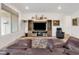 Cozy living room featuring wood-style floors, a TV, leather sofa, and a recliner at 647 Quarry Pass, Mesquite, NV 89034