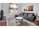 Cozy living room with gray sofa, a patterned rug, and colorful modern wall art at 647 Quarry Pass, Mesquite, NV 89034