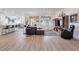 Spacious open-concept living area featuring wood floors and seamlessly connected to the kitchen and dining area at 647 Quarry Pass, Mesquite, NV 89034