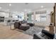 Open-concept living room showcasing wood flooring, seamlessly connecting the kitchen and dining area at 647 Quarry Pass, Mesquite, NV 89034
