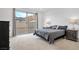 Serene main bedroom featuring large slider doors, neutral tones, and views of the outdoors at 647 Quarry Pass, Mesquite, NV 89034