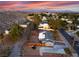 Expansive aerial view of a residential area showcasing mountain views and mature trees at 650 Arizona St, Boulder City, NV 89005