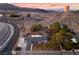 Wide aerial shot of a single-story home in a desert landscape with mountains in the distance at 650 Arizona St, Boulder City, NV 89005