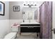 This bathroom offers a black sink cabinet, a toilet, and a shower with a curtain at 650 Arizona St, Boulder City, NV 89005
