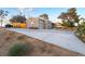Single-story home with a spacious driveway, grey siding, and desert landscaping at 650 Arizona St, Boulder City, NV 89005