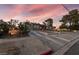 Wide view of the home from the street showing landscaping and a sloped driveway with easy street access at 650 Arizona St, Boulder City, NV 89005