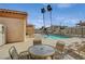 Community pool with patio furniture and desert landscaping in a gated area at 6916 Dorita Ave # 101, Las Vegas, NV 89108