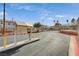 Community entrance featuring mature trees, well-maintained landscaping, and gate at 6916 Dorita Ave # 101, Las Vegas, NV 89108