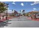 Community gated entrance with desert landscaping and well-maintained buildings with tile roofs at 6916 Dorita Ave # 101, Las Vegas, NV 89108