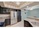 Kitchen featuring stainless steel refrigerator, granite countertops, and dark cabinets at 6916 Dorita Ave # 101, Las Vegas, NV 89108