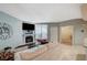 Relaxing living room featuring a cozy fireplace, a large window, and a comfortable seating area at 6916 Dorita Ave # 101, Las Vegas, NV 89108
