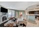 Comfortable living room with a fireplace, seamlessly integrated with a modern kitchen for convenient living at 6916 Dorita Ave # 101, Las Vegas, NV 89108