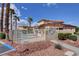 Community poolside features desert landscaping, palm trees, and a gated area at 6916 Dorita Ave # 101, Las Vegas, NV 89108