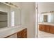 Bathroom featuring double vanity, large mirror and access to closet at 7140 Pascal Dr, Las Vegas, NV 89156