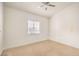 Bright bedroom with carpet flooring, ceiling fan, and a window at 7140 Pascal Dr, Las Vegas, NV 89156