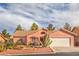 Charming single-story home with a desert landscape, barrel tile roof, and a two car garage at 7140 Pascal Dr, Las Vegas, NV 89156